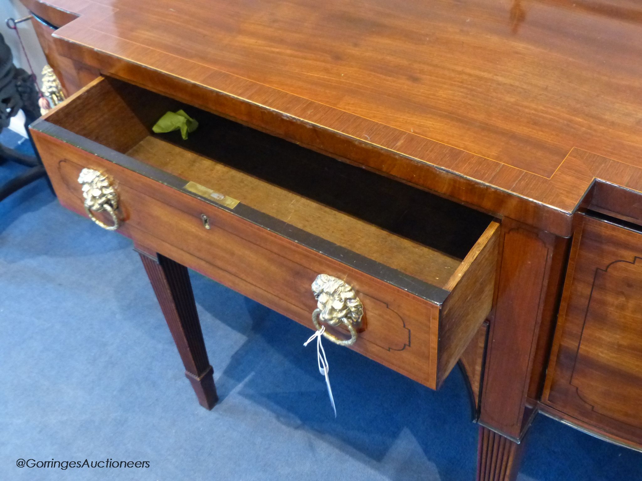 A George III mahogany bow-breakront sideboard, 152cm long, 116.5 cm high to top brass rail, 76 cm deep